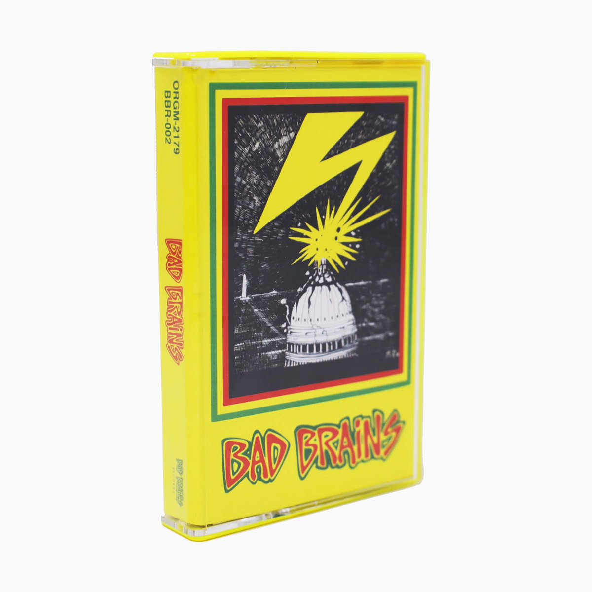 The “Bad Brains” Cassette Tape comes in a yellow case featuring a cartoon lightning bolt striking the US Capitol dome, framed by a red and green border. The band’s name, Bad Brains, appears in bold red letters at the bottom, an iconic design that perfectly captures the raw energy of tracks like “Pay To Cum” and the rebellious spirit behind “Banned In D.C.”.